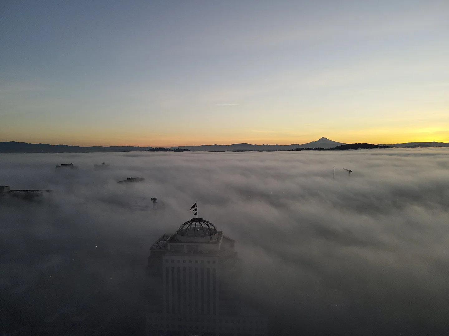 Aerial drone view of Mt Hood above the fog at sunrise